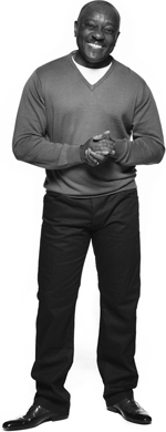 Man smiling clasping hands