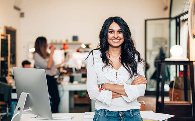 Smiling woman facing camera with arms crossed