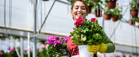 Woman holding pots of flowers