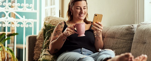 Woman sitting looking at a phone