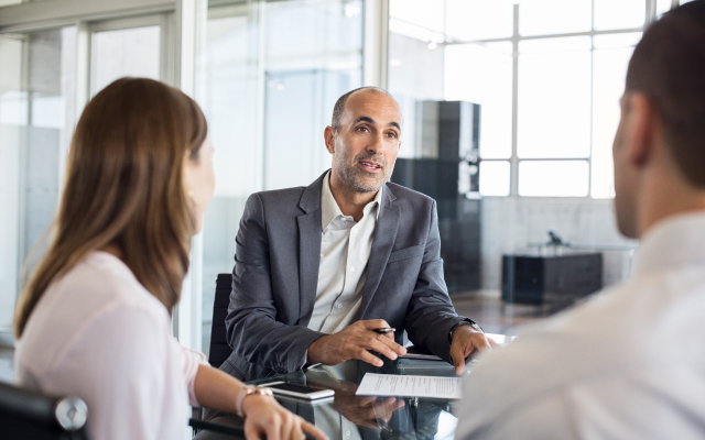 Man talking with clients in meeting