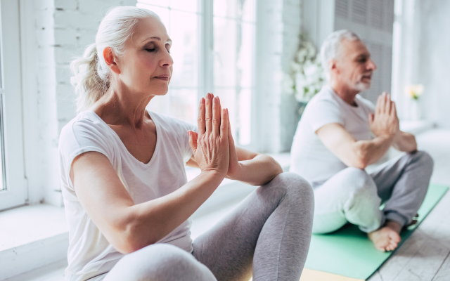 Woman and man doing yoga