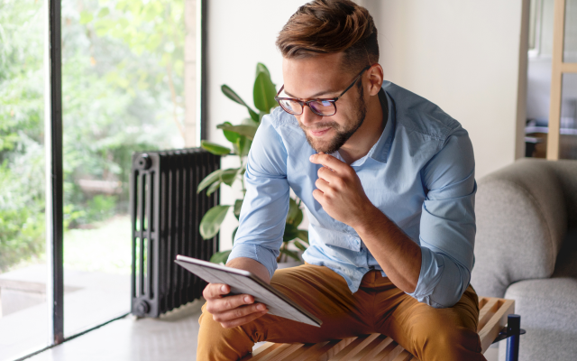 Man sitting looking at tablet