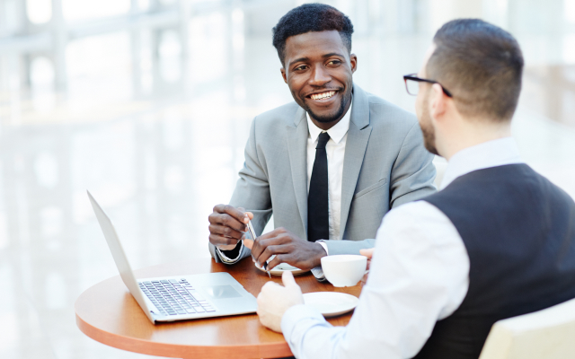 Two men chatting over coffee