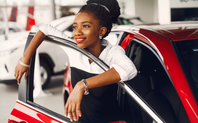 Woman standing with new car