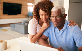 Couple sitting looking at computer screen