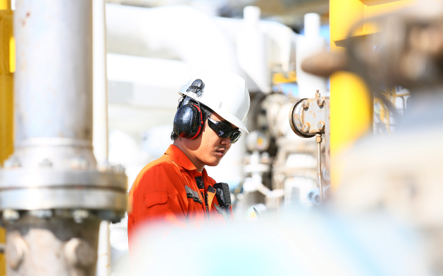 Image of man at an oil plant