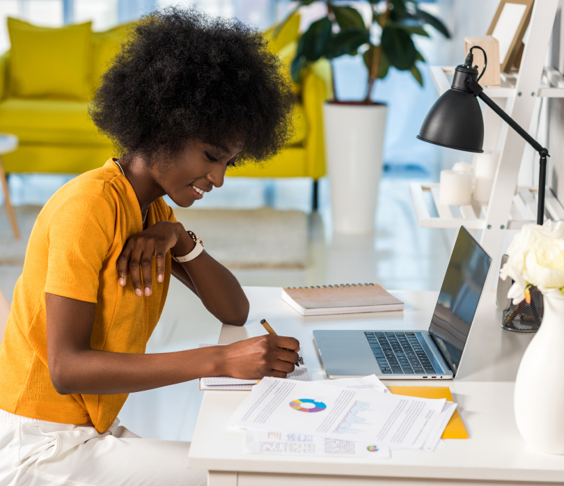 Woman in yellow t-shirt working at desk