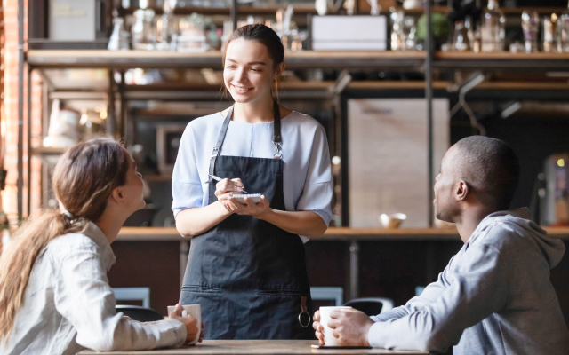 Woman taking order in café