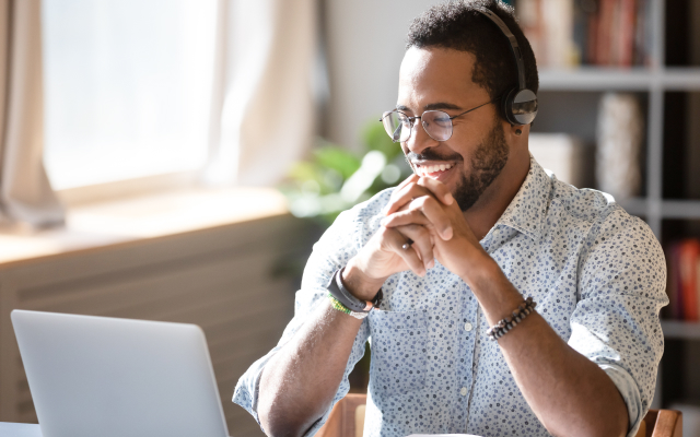 Man smiling at laptop