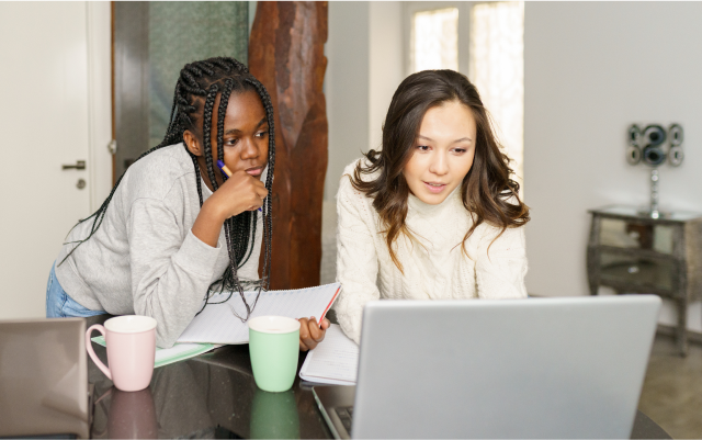 Two women looking at a laptop