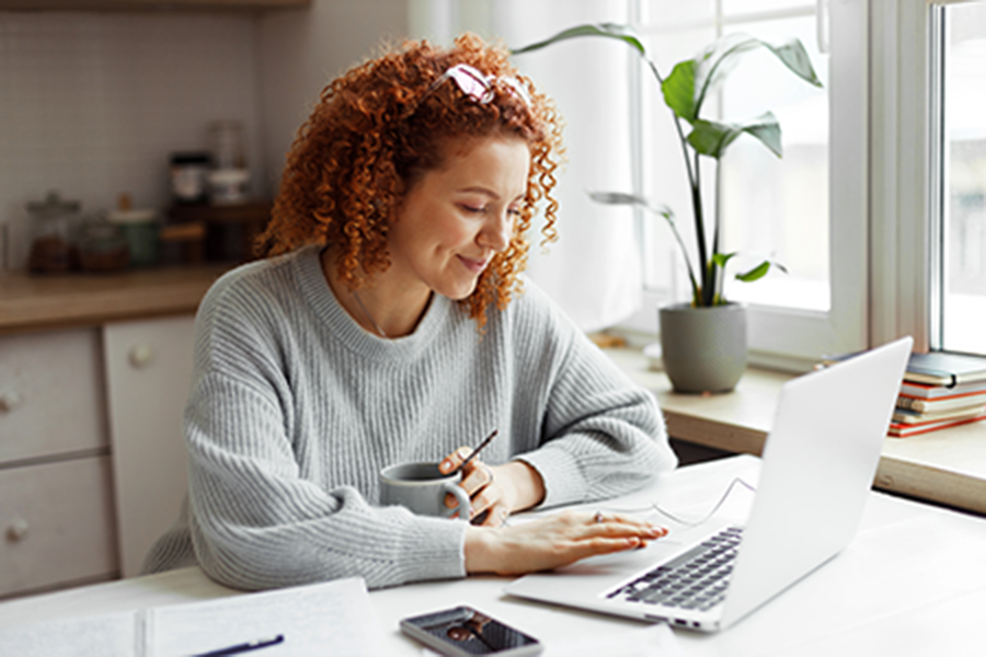 Person taking notes from a webinar