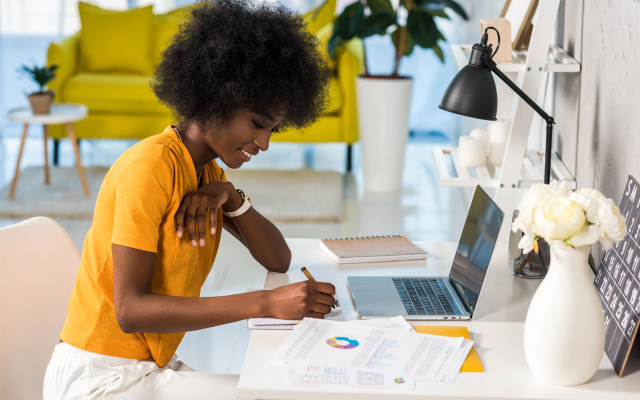 woman sitting at desk working on laptop