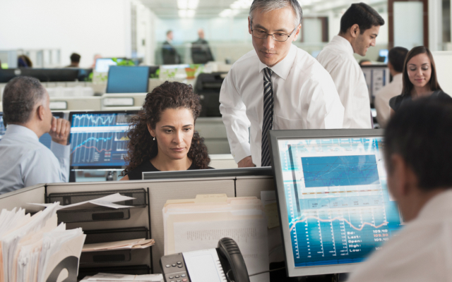 man supporting woman at desktop screen