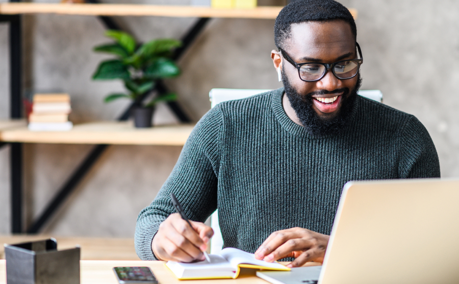 Man smiling at laptop