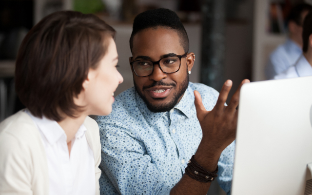 Man and woman chatting at computer