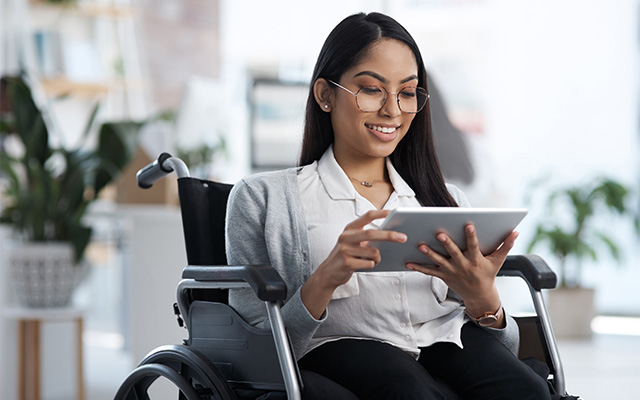 Woman in wheelchair on tablet