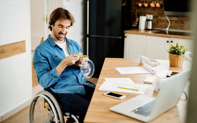 Man in wheelchair at desk