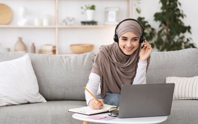 Woman with headphones on laptop