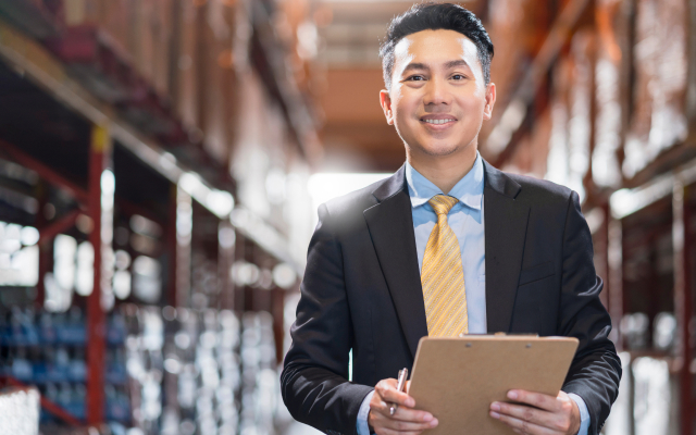 Man in suit standing in warehouse