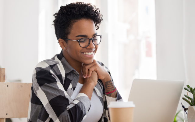 Woman sitting at laptop smiling