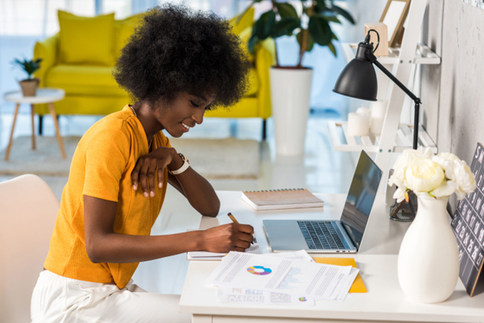 Woman sitting at desk working on laptop