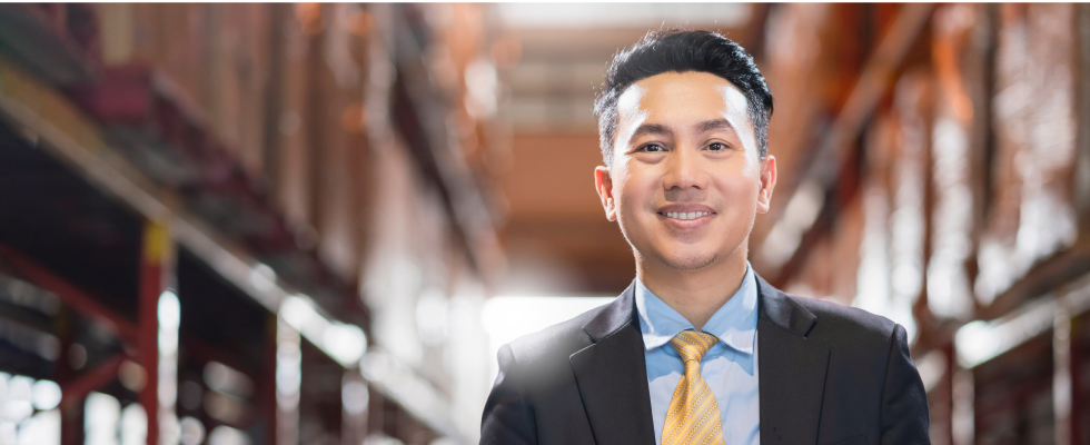 Man in suit standing in warehouse