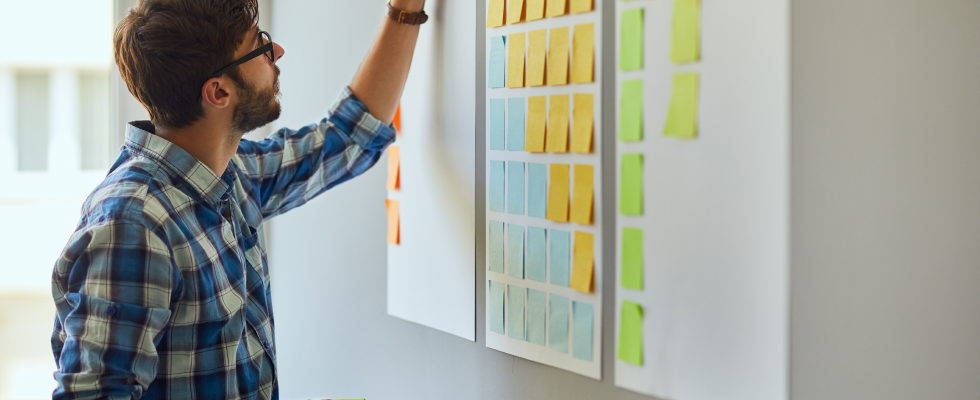 Image of man writing on a white board