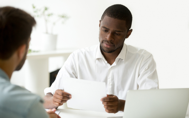 Two men in meeting looking at paperwork