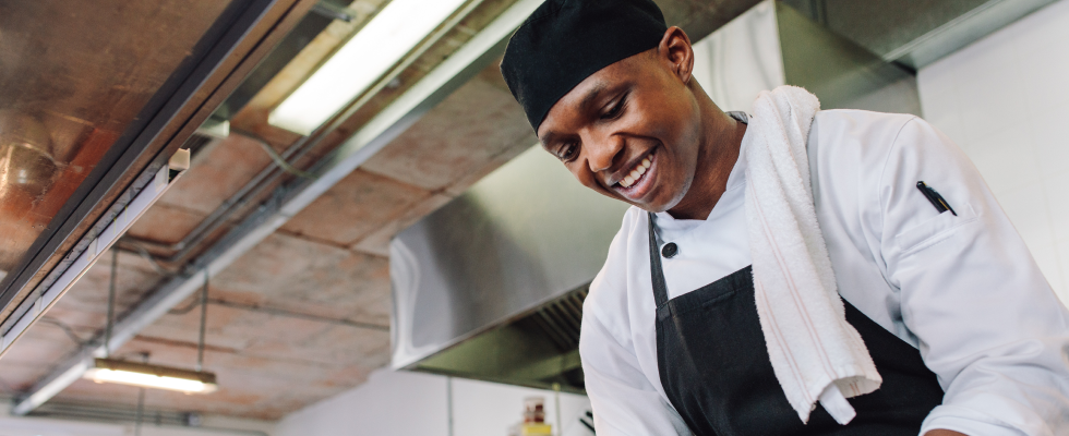 A man in chef clothing in the kitchen