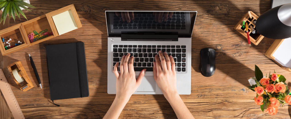 Birdseye view of a person typing on laptop