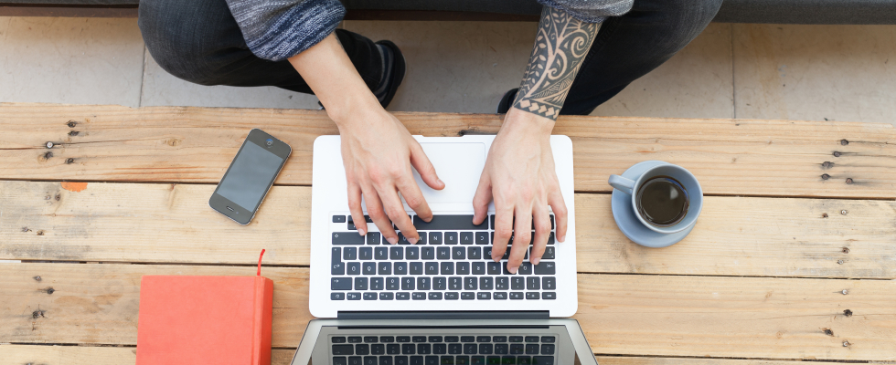 birds eye view of person typing on laptop