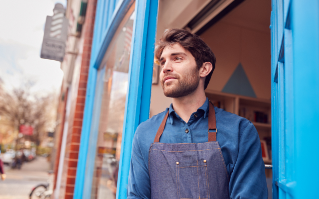 Man standing at the front door looking out