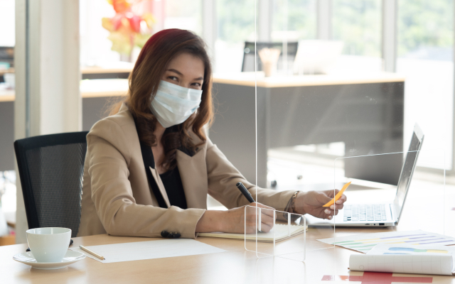 Woman wearing facemask at desk