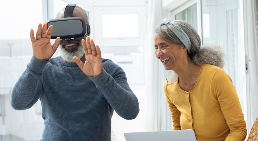 One man with virtual headset and one woman next to him
