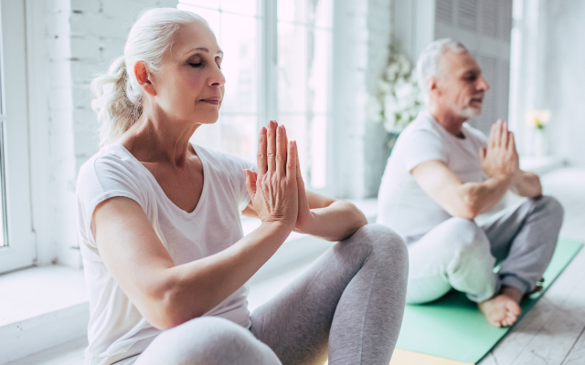 man and woman doing yoga pose