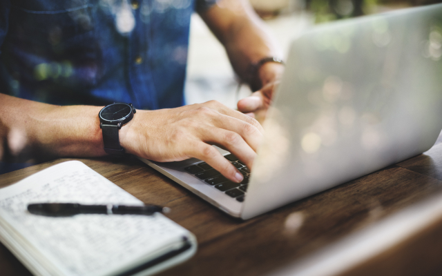 Man typing on a laptop