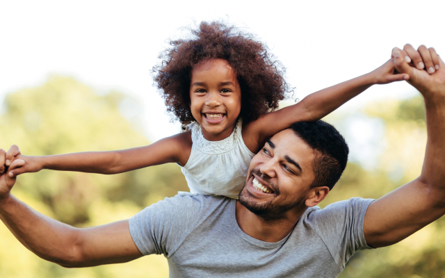 Young man carrying a child