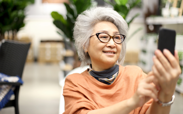 Elderly woman looking at her smartphone