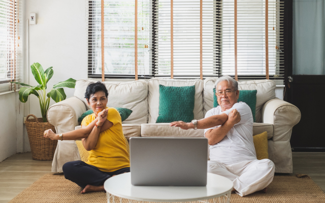 People sitting in living room doing yoga