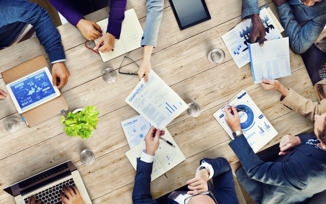 Bird's-eye view of people working in meeting