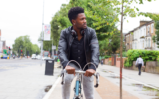 Man cycling down street