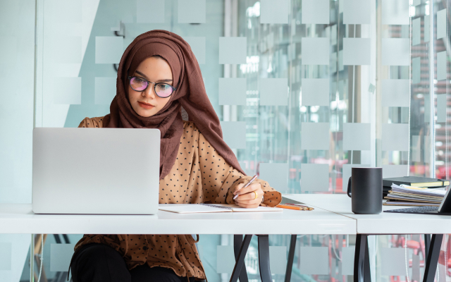 Woman working on laptop at desk