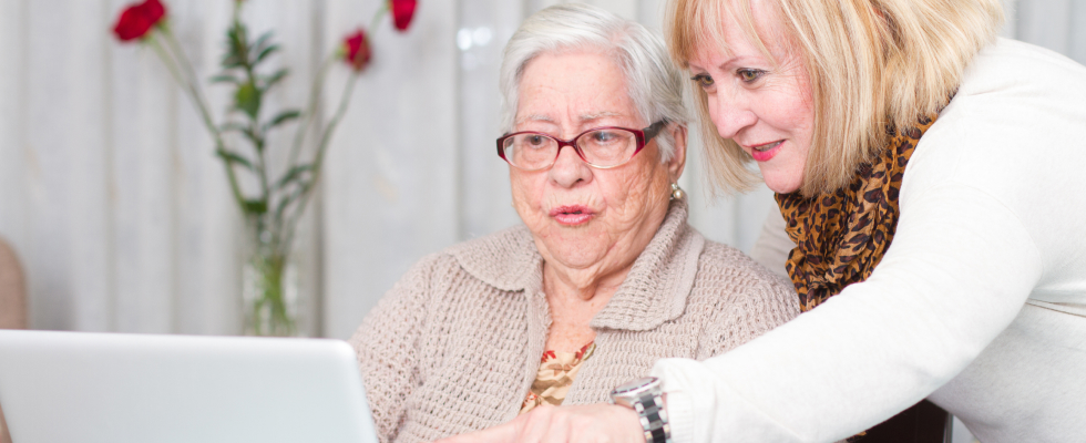 Two women sitting at a laptop