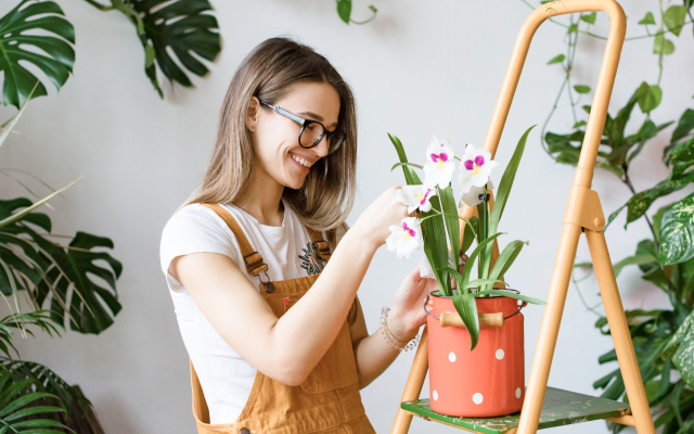 Woman potting flowers in a pot