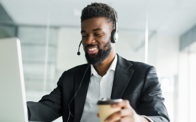 Man sitting at desk with a headset on