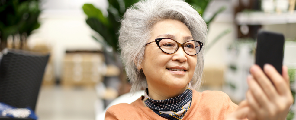 Older woman looking at smartphone