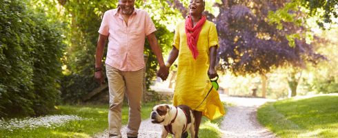 Older couple outside holding hands and laughing