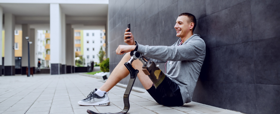 Man sitting on floor talking on his smartphone