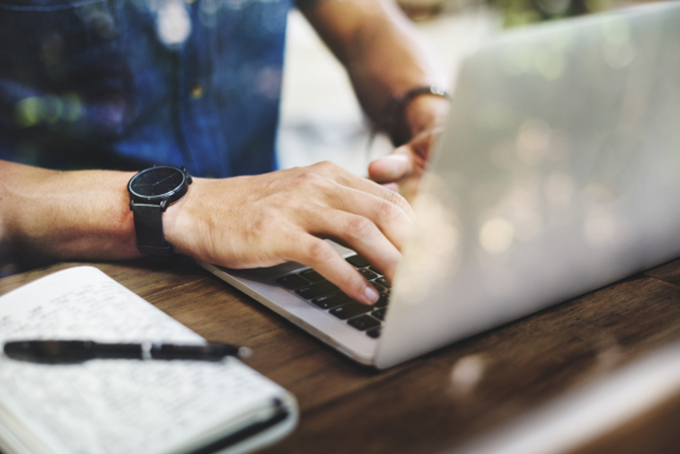 A man typing on laptop